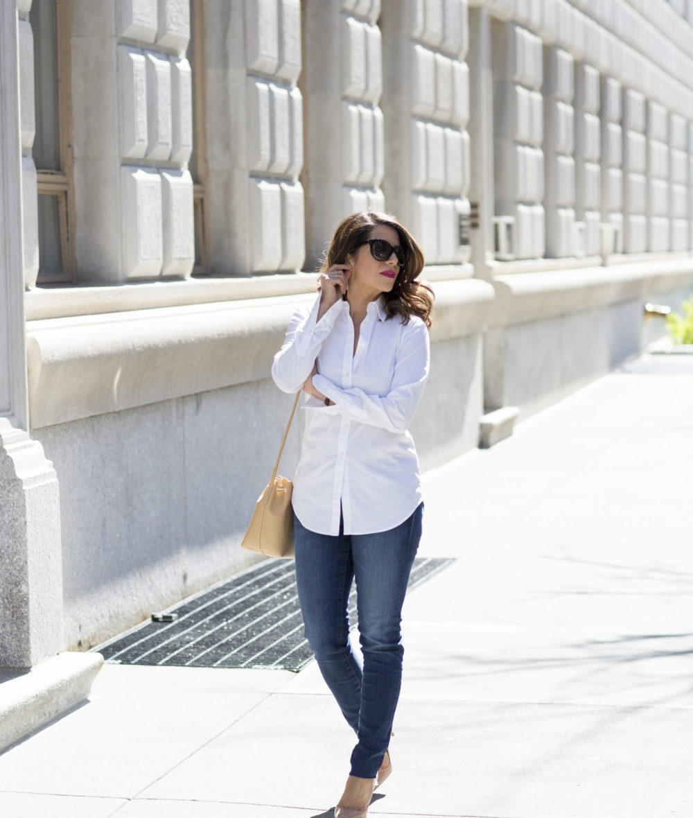 the corporate catwalk wearing a white button down shirt and denim with high heels in new york city for a casual weekend look