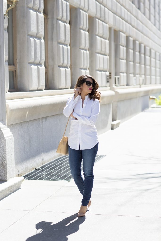 the corporate catwalk wearing a white button down shirt and denim with high heels in new york city for a casual weekend look 
